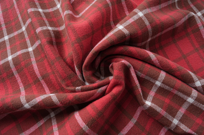 Close-up of red plaid flannel fabric gathered into soft folds