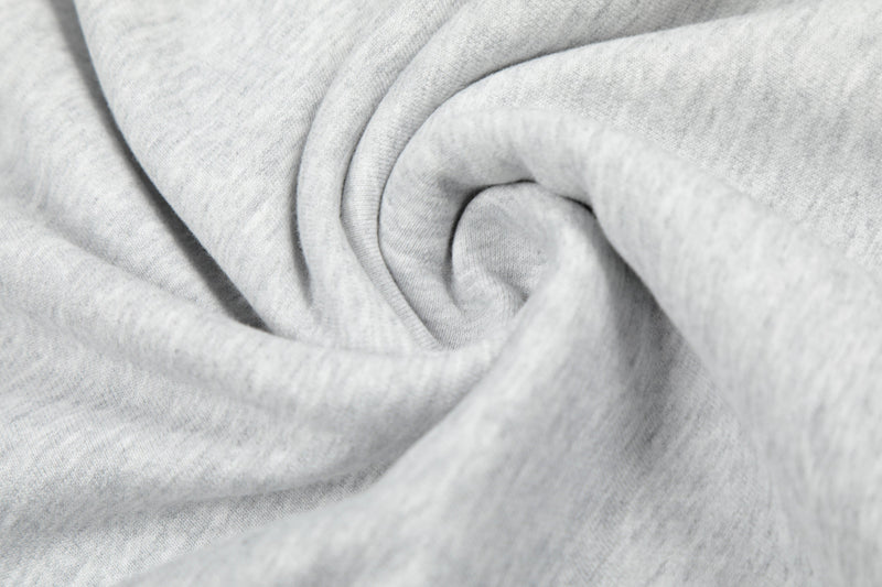 Close-up of light gray hoodie fabric folds and soft knit texture