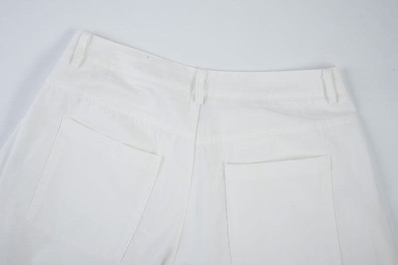 Close-up of white cargo pants back pocket and waistband detail