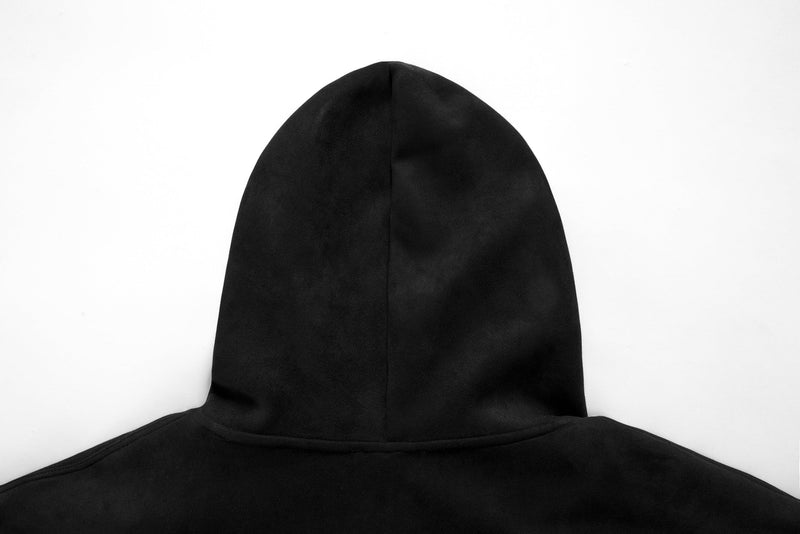 Close-up of black hoodie hood with gothic embroidered lettering across the front edge