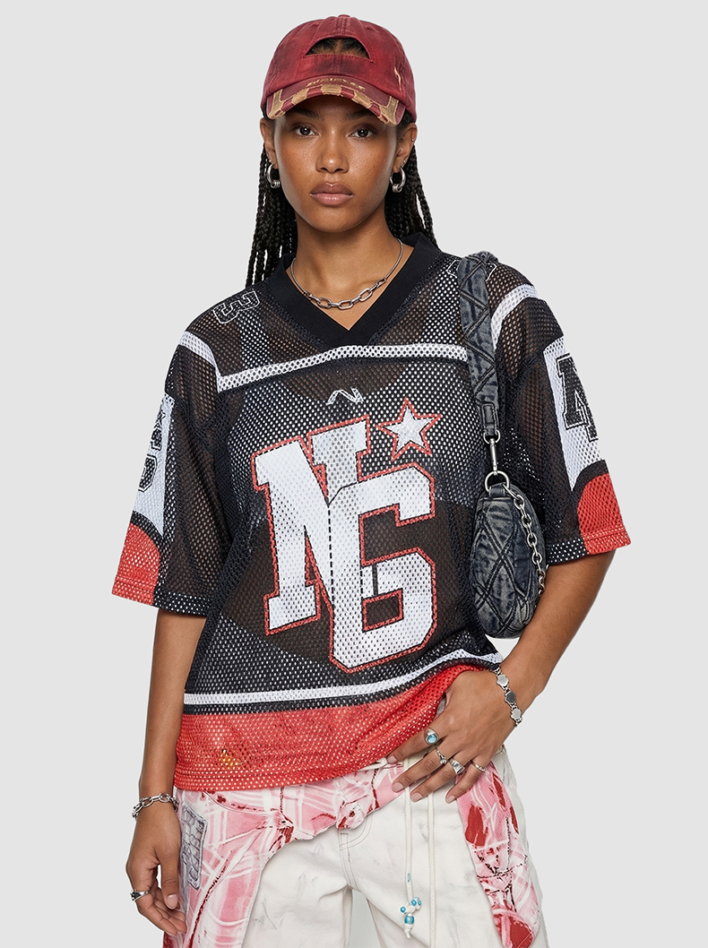 Model wearing a black mesh jersey T-shirt with bold NC graphic, red accents, and oversized streetwear fit
