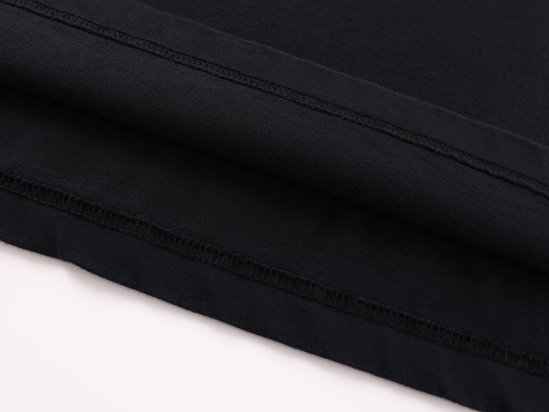 Close-up of sleeve cuff stitching on black long-sleeve tee