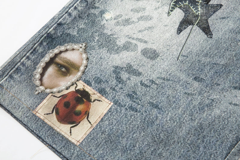 Close-up of ladybug patch and eye cutout detail on acid wash denim shorts