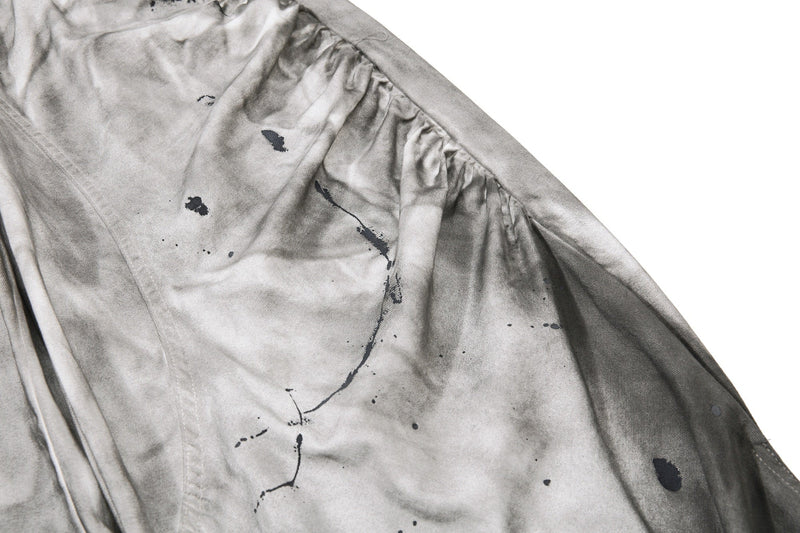 Close-up of side panel and seam on gray jeans with dirty wash finish
