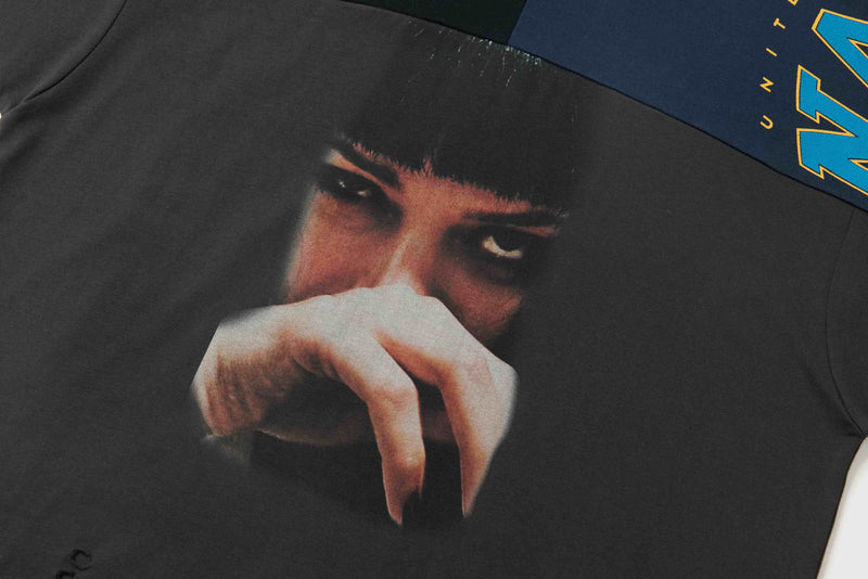 Oversized black graphic tee with a distressed face print and blue panel detail on the shoulder