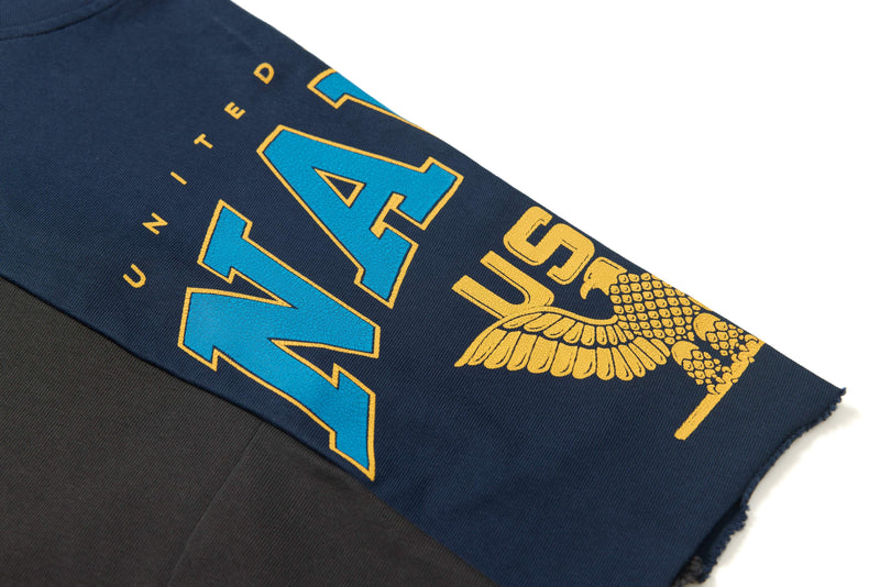 Navy and black oversized graphic tee with bold blue and yellow varsity-style print and wing detail on sleeve