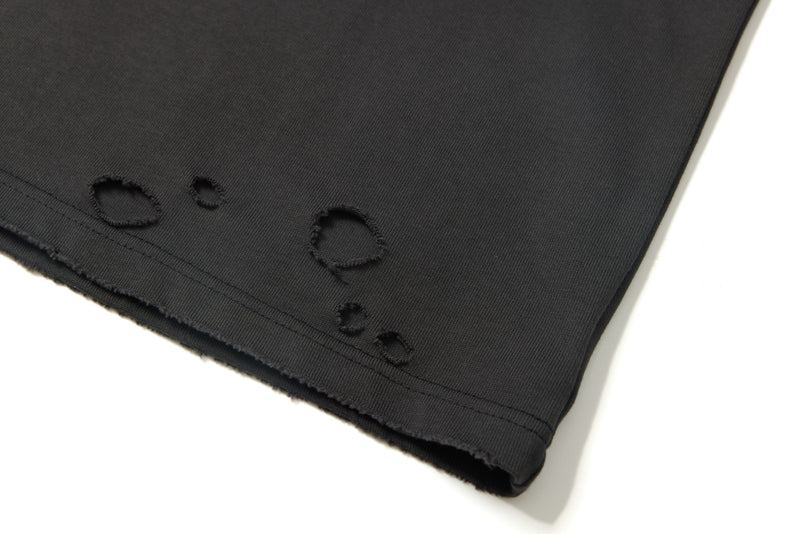 Black distressed oversized graphic tee with raw hem and subtle panel detail on the sleeve edge