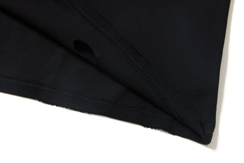 Black tee sleeve cuff and hem stitching close-up