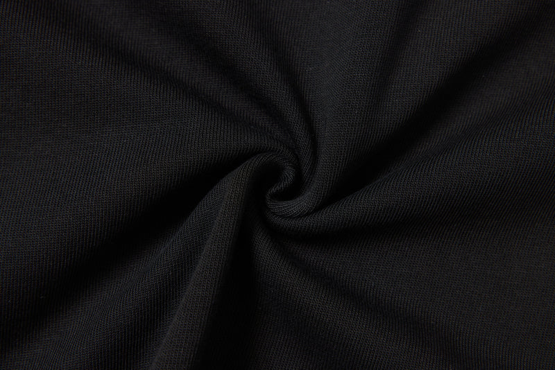 Black ribbed knit fabric twisted into a spiral close-up