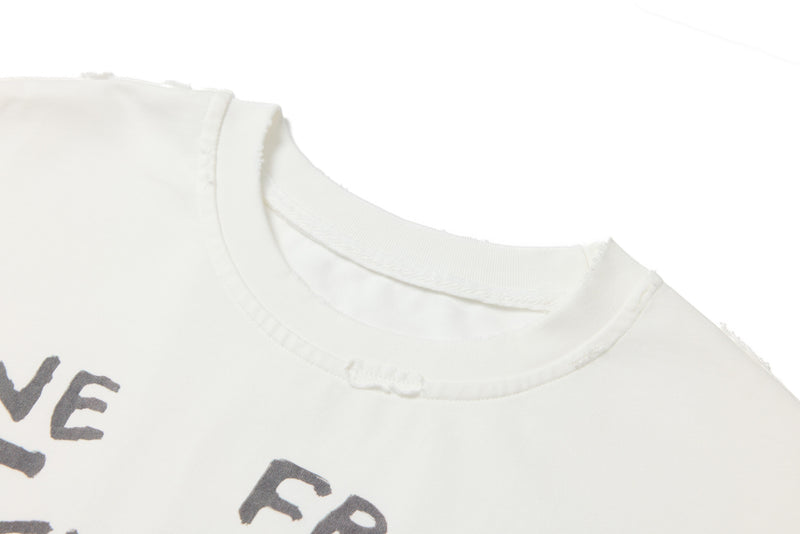 Close-up of white tee neckline with raw distressed edge and printed lettering