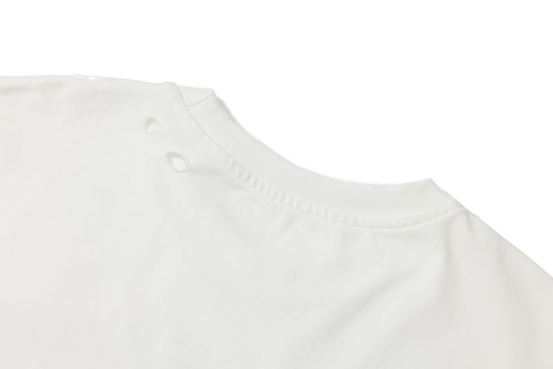 Close-up of white tee shoulder and neckline with distressed raw-edge finish
