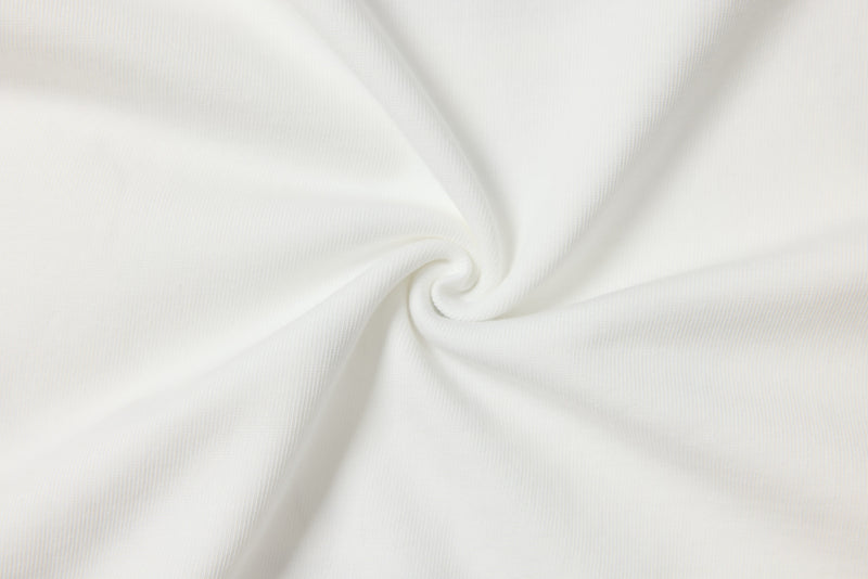 Close-up of white tee fabric gathered in a swirl on a white background