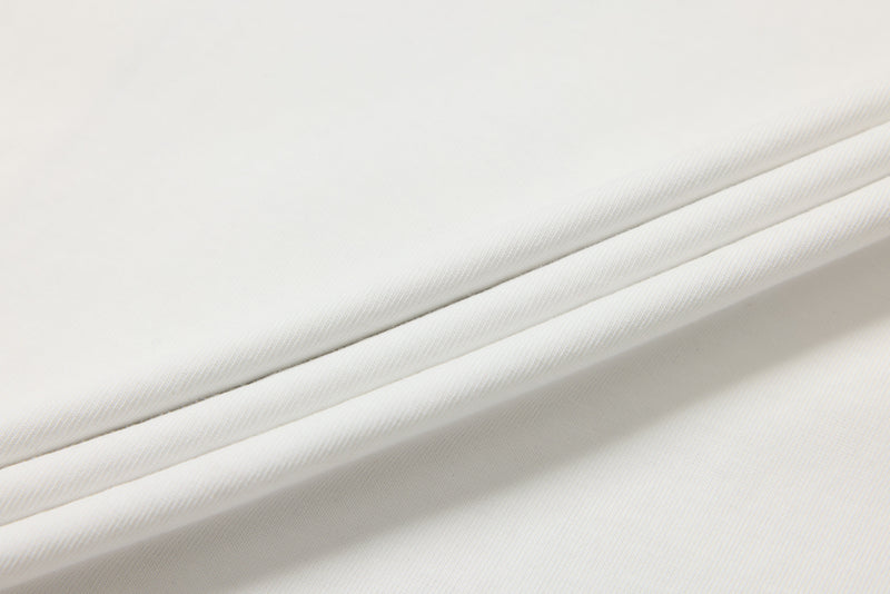 Close-up of smooth white fabric folds on the tee body