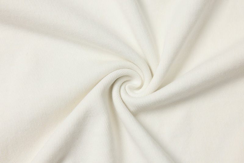 White fabric swirl close-up showing smooth knit texture and draped folds