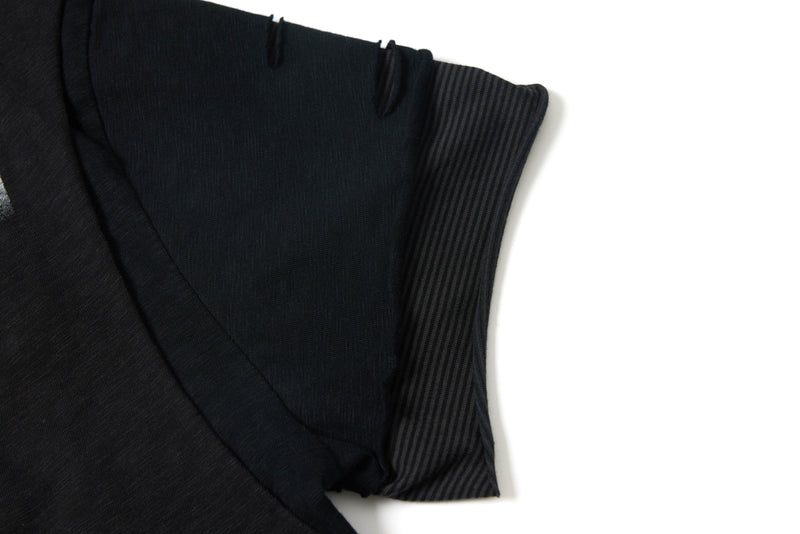 Washed black distressed layered graphic tee with striped sleeve detail and raw seam accents