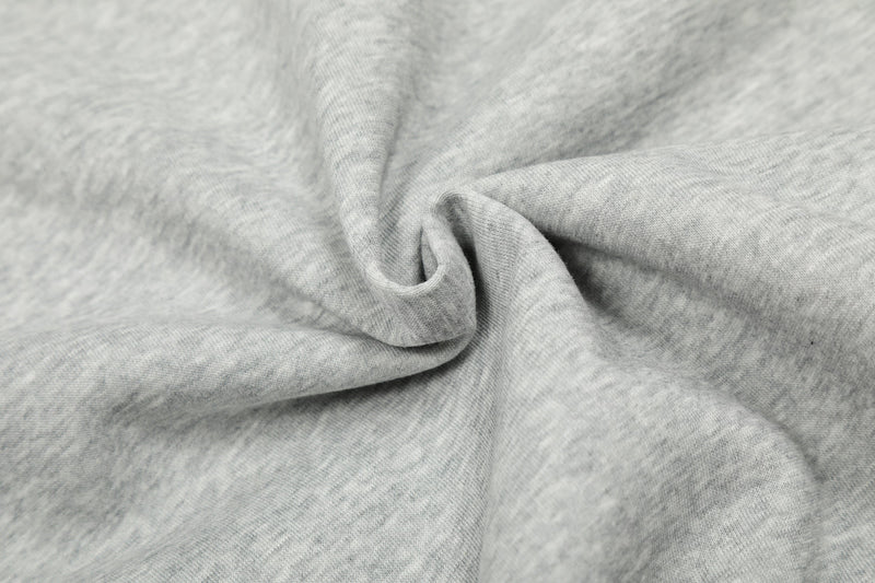Close-up of light gray hoodie fabric with soft brushed texture and fold