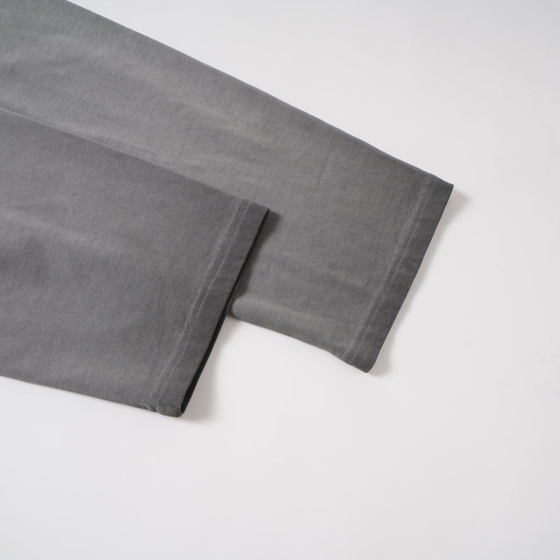 Folded washed grey long sleeve tee sleeves with stitched cuffs shown side by side