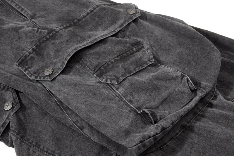 Close-up of side cargo pocket and flap details on washed black pants