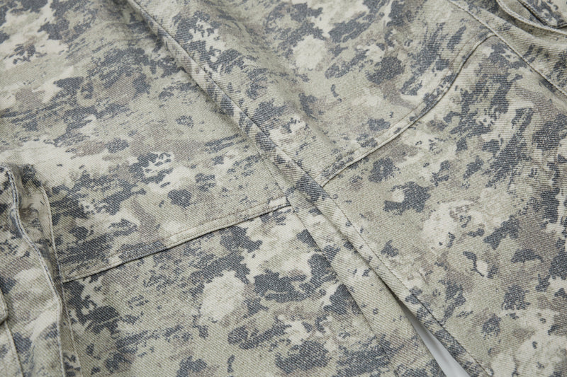 Close-up of camouflage fabric and stitched panel seam on the pant leg