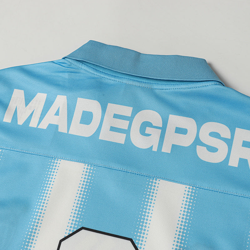 Light blue football jersey with white vertical stripes, bold back lettering, and a ribbed collar detail
