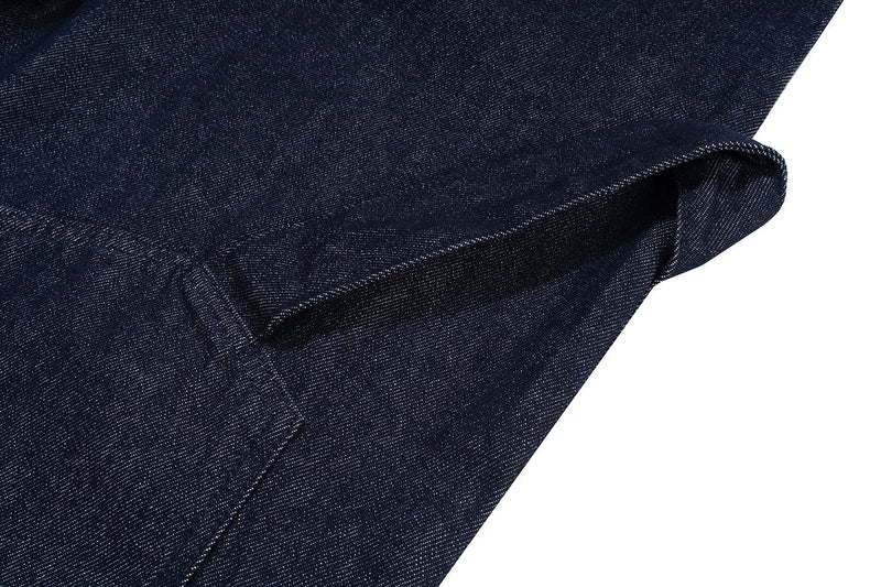 Close-up of rolled outer hem on dark indigo denim shorts