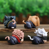 Displayed on a wooden surface, the four small figures resemble an adorable Jujutsu Kaisen Chibi Figure Set—4-piece PVC collection with kawaii charm, featuring anime-style hair and tails. They appear to lounge adorably against a blurred brown fence background.