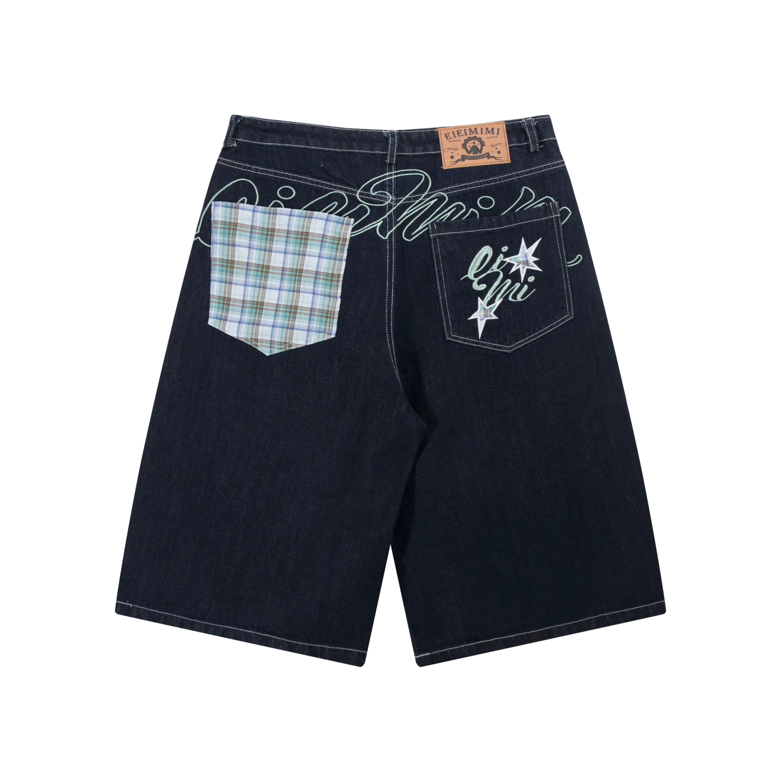 Back view of dark indigo wide-leg denim shorts with contrast plaid patch pocket and embroidered star graphic pocket