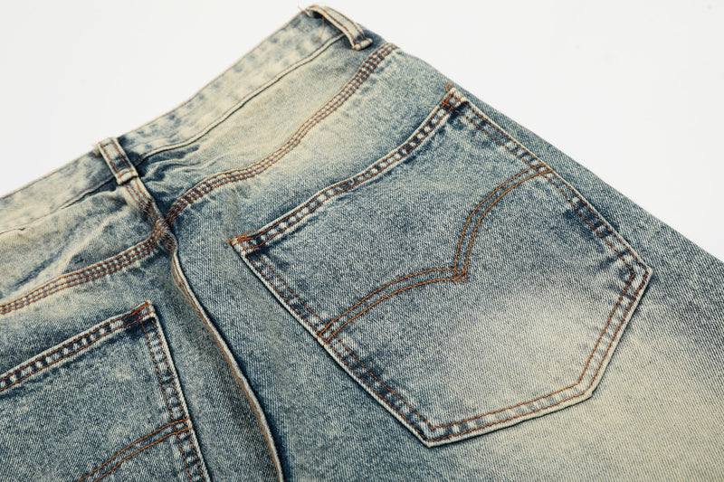 Close-up of light wash jeans back pocket and yoke seam with vintage wash pattern