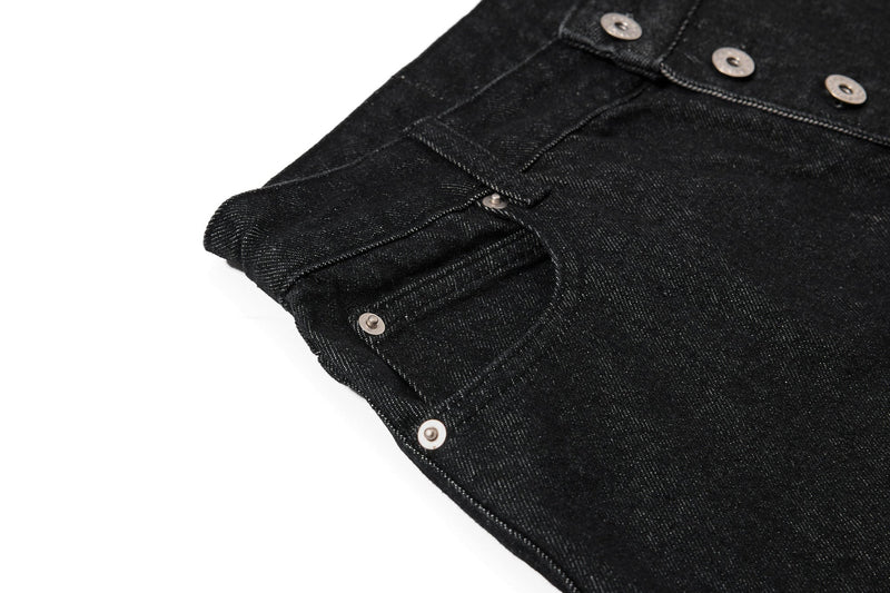 Close-up of the front pocket and side seam on black denim shorts
