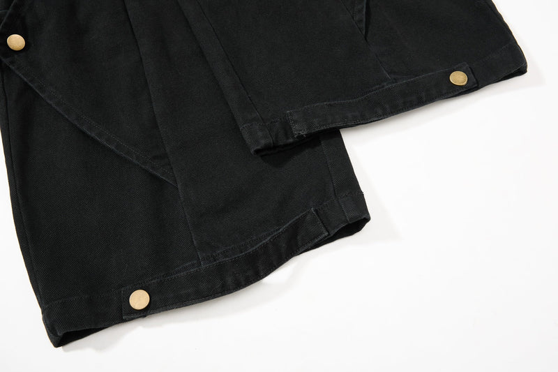 Close-up of black pant hem and snap-closed cuff detail