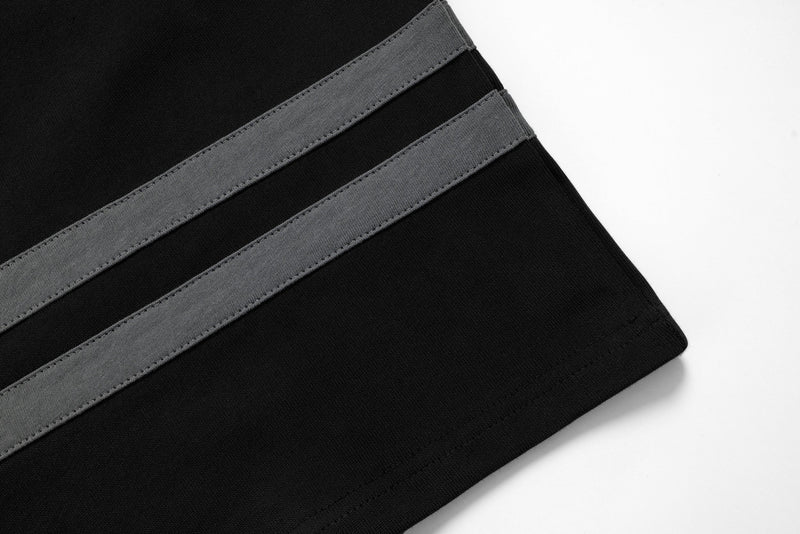 Close-up of black sleeve hem with two gray stripes on the jersey