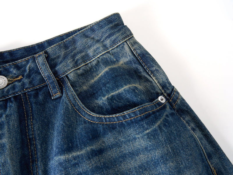 Close-up of front right pocket and waistband on vintage washed blue denim