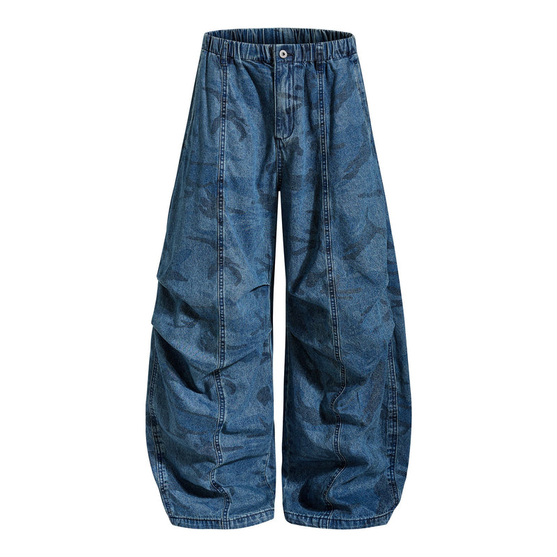 Front view of washed blue camo baggy jeans with wide legs and elastic waistband