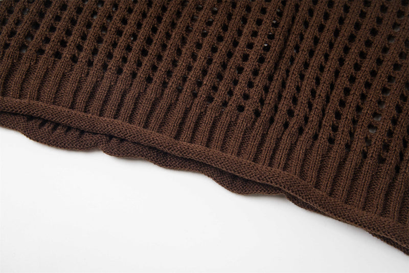 Close-up of brown open-knit sweater hem with ribbed trim