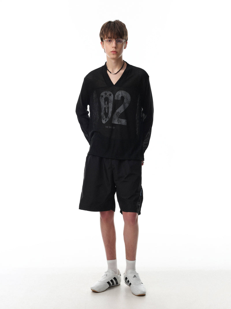 Black long sleeve V-neck tee worn on model with faded 02 print and relaxed fit