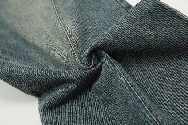 Close-up of folded vintage wash denim fabric and seam stitching