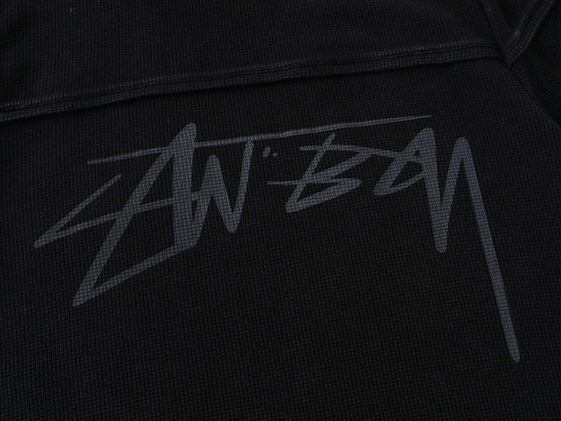 Black waffle knit T-shirt with a large gray Seakoff script logo graphic on the chest