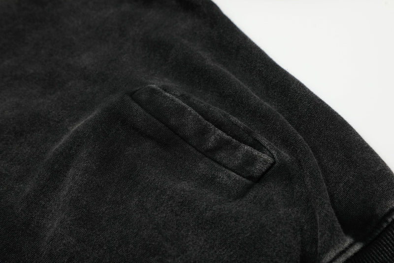 Black hoodie jacket side pocket detail on washed fabric