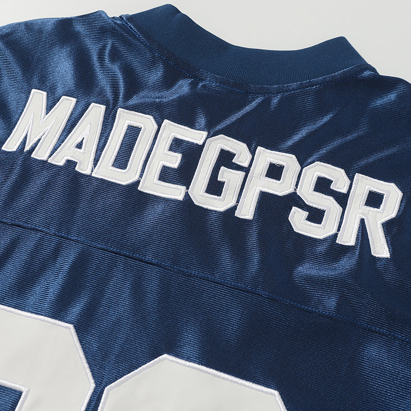 Navy retro football jersey tee with white varsity lettering and large number 06 on the back