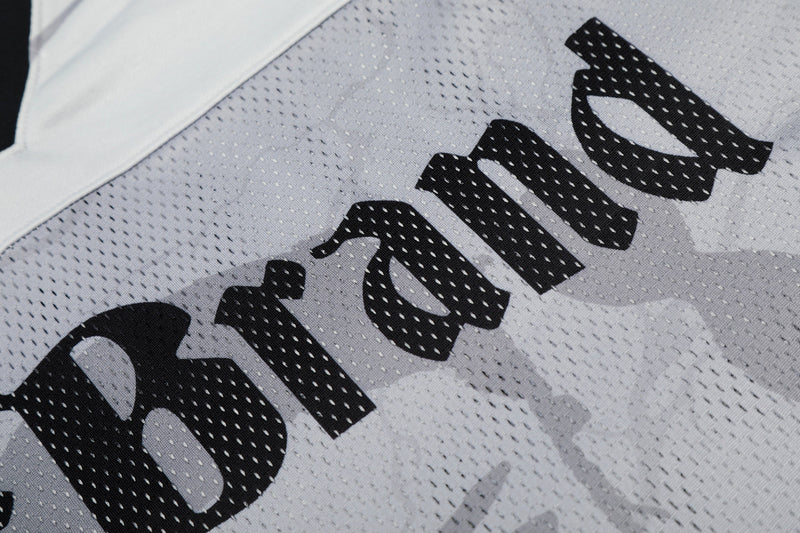 Close-up of a white mesh football jersey with bold black number 99 graphic print