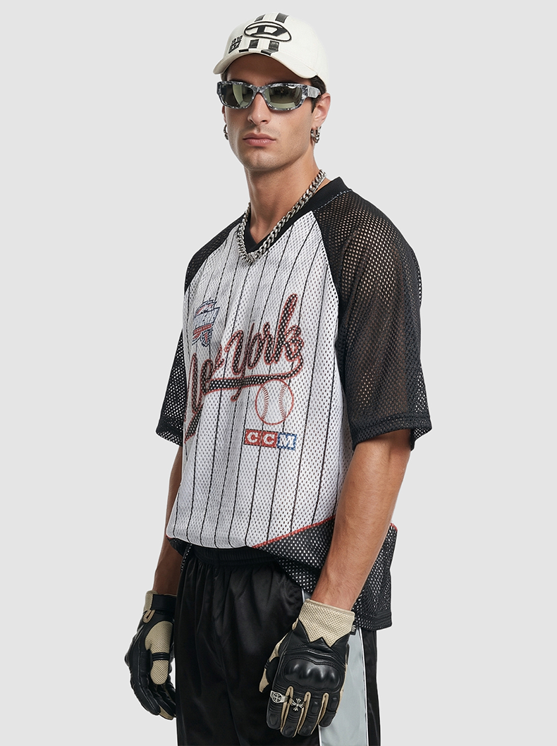 Black and white New York pinstripe mesh jersey T-shirt worn with sunglasses, cap, chain necklace, and gloves