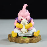 The Seakoff Majin Buu Collectible Figure, 8.5cm tall, is perfect for Dragon Ball Z fans. It features the pink character with a curled antenna and a rocky base, wearing a purple cape, yellow gloves and boots, while affectionately embracing a small white bunny.