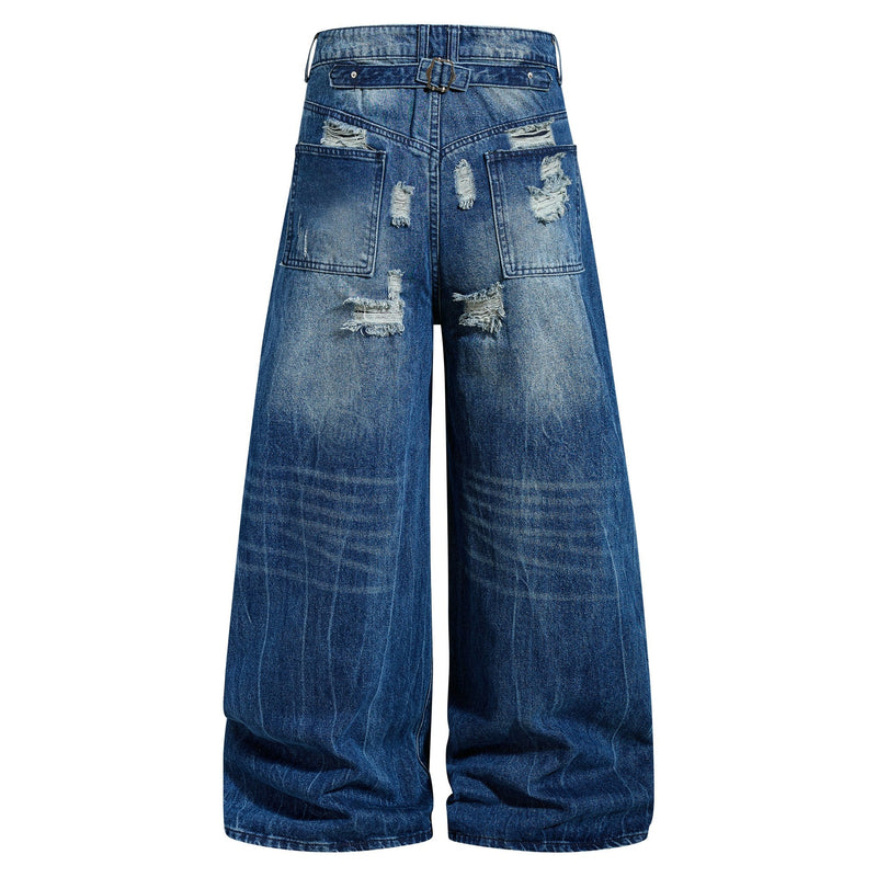 Back view of wide-leg distressed blue jeans with belt detail and ripped patches