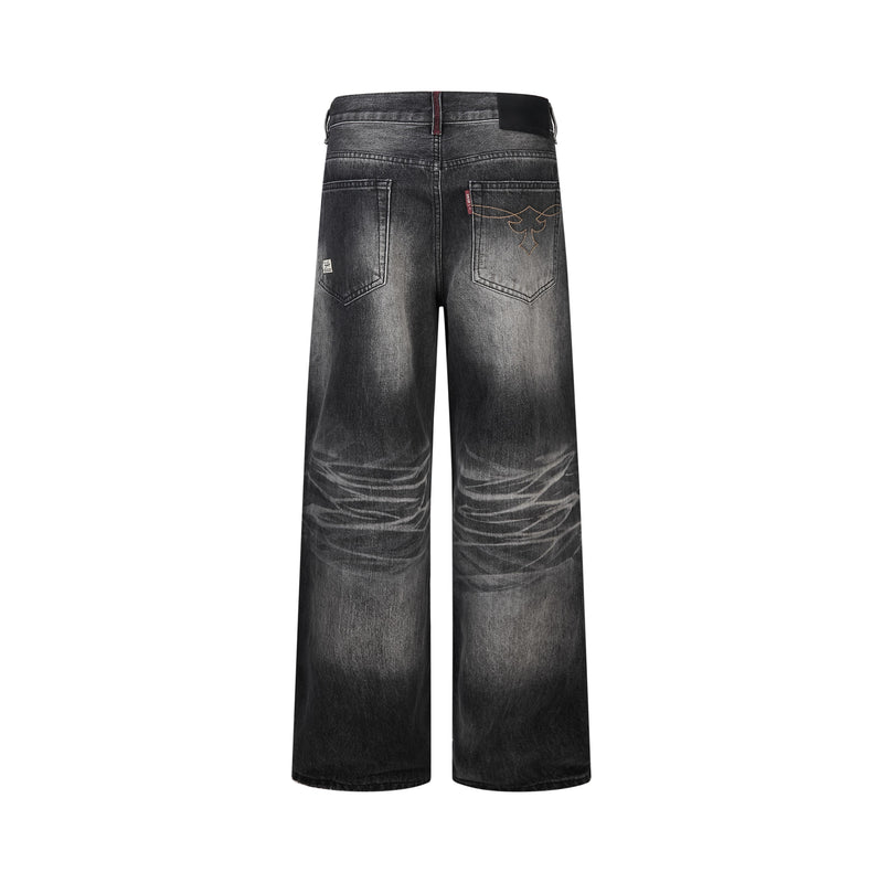 Back view of dark charcoal wide-leg jeans with faded knees and stitched back pockets