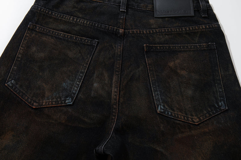 Close-up of the back pockets on dark grunge-wash wide-leg jeans