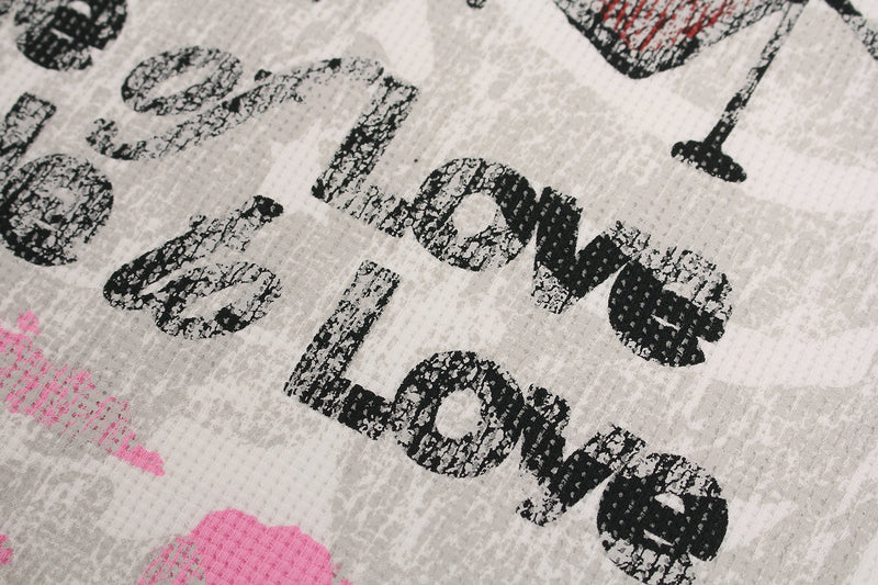 Close-up of distressed black and pink Made of Love graphic print on a white streetwear tee