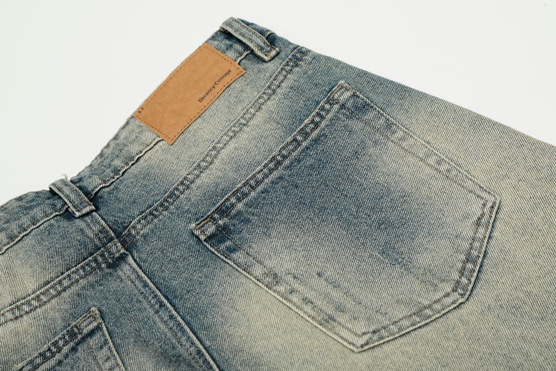 Close-up of back waistband and patch label on faded blue jeans with contrast fading