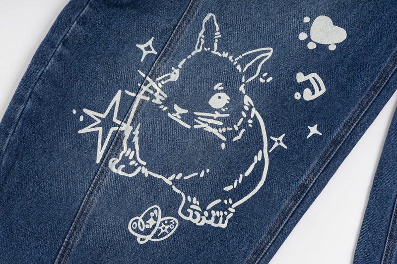 Close-up of blue jeans leg with white bunny graphic, stars, and small heart