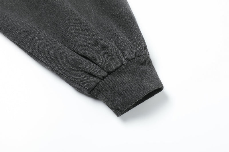 Close-up of black jacket sleeve cuff with ribbed knit trim