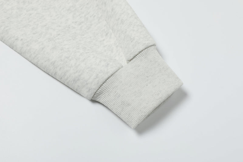 Close-up of heather gray ribbed cuff and sleeve hem